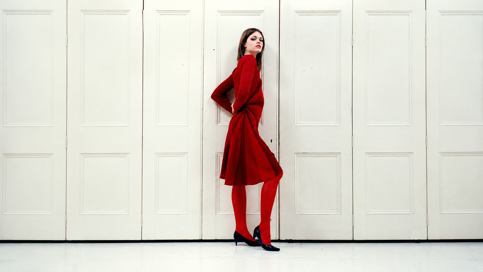 Alice Lee — red dress against cream wood doors